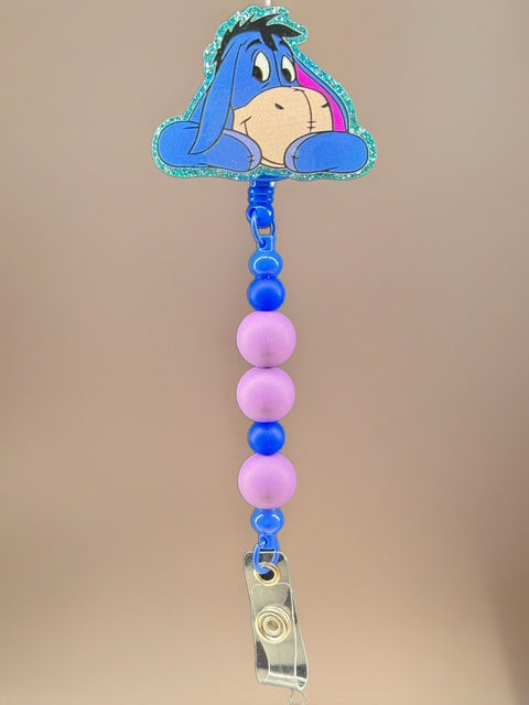 Sad Blue Donkey Badge Reel – Purple & Blue Beaded Clip
